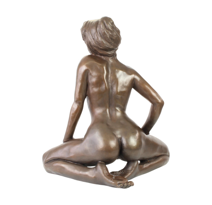 Large bronze sculpture of a kneeling female nude