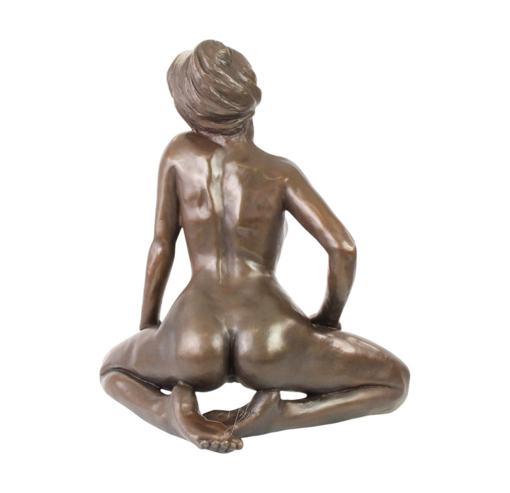 Large bronze sculpture of a kneeling female nude