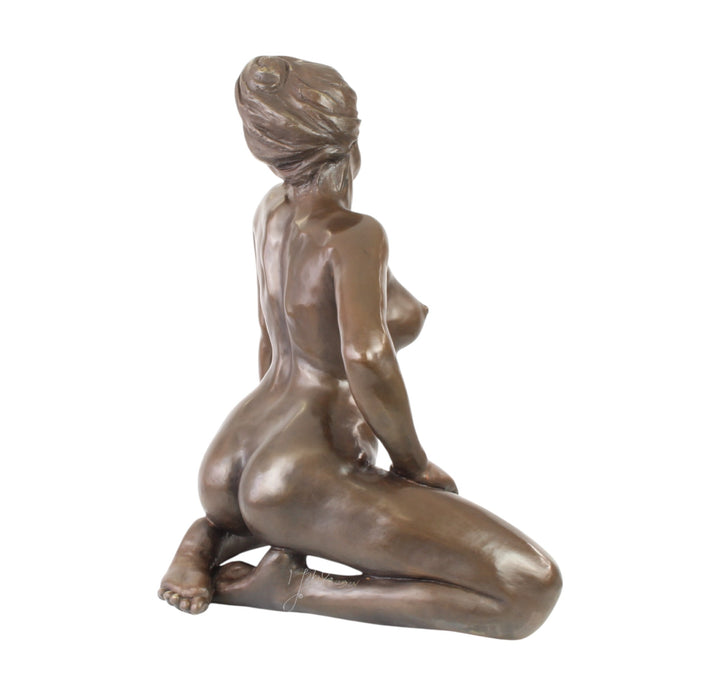 Large bronze sculpture of a kneeling female nude