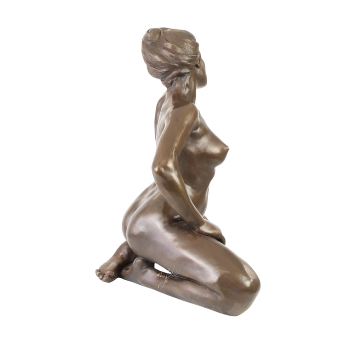 Large bronze sculpture of a kneeling female nude