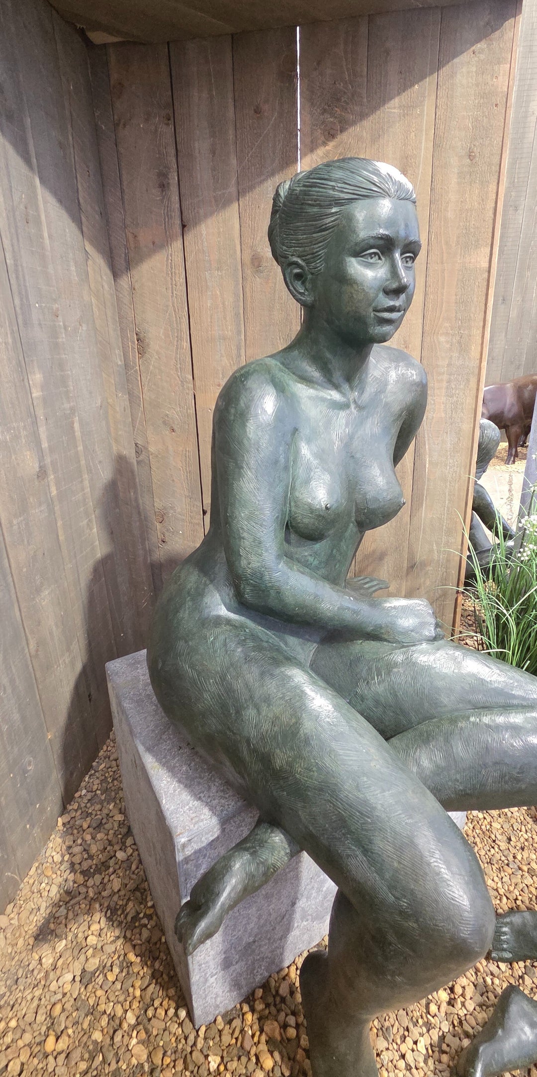 Bronze sculpture of a sitting female nude