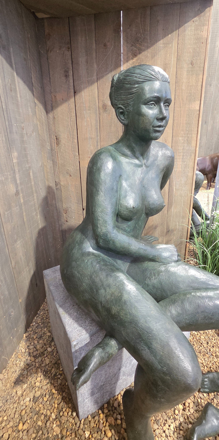 Bronze sculpture of a sitting female nude