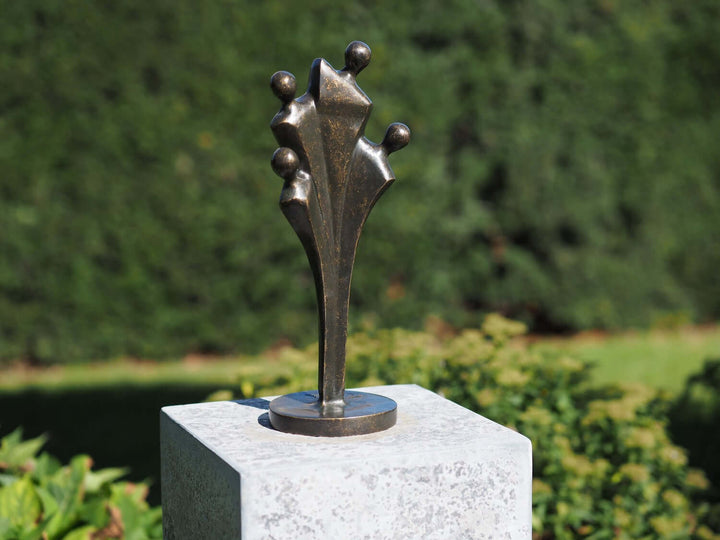 Abstract bronze sculpture of a family of four, featuring minimalist design, suitable for outdoor display.