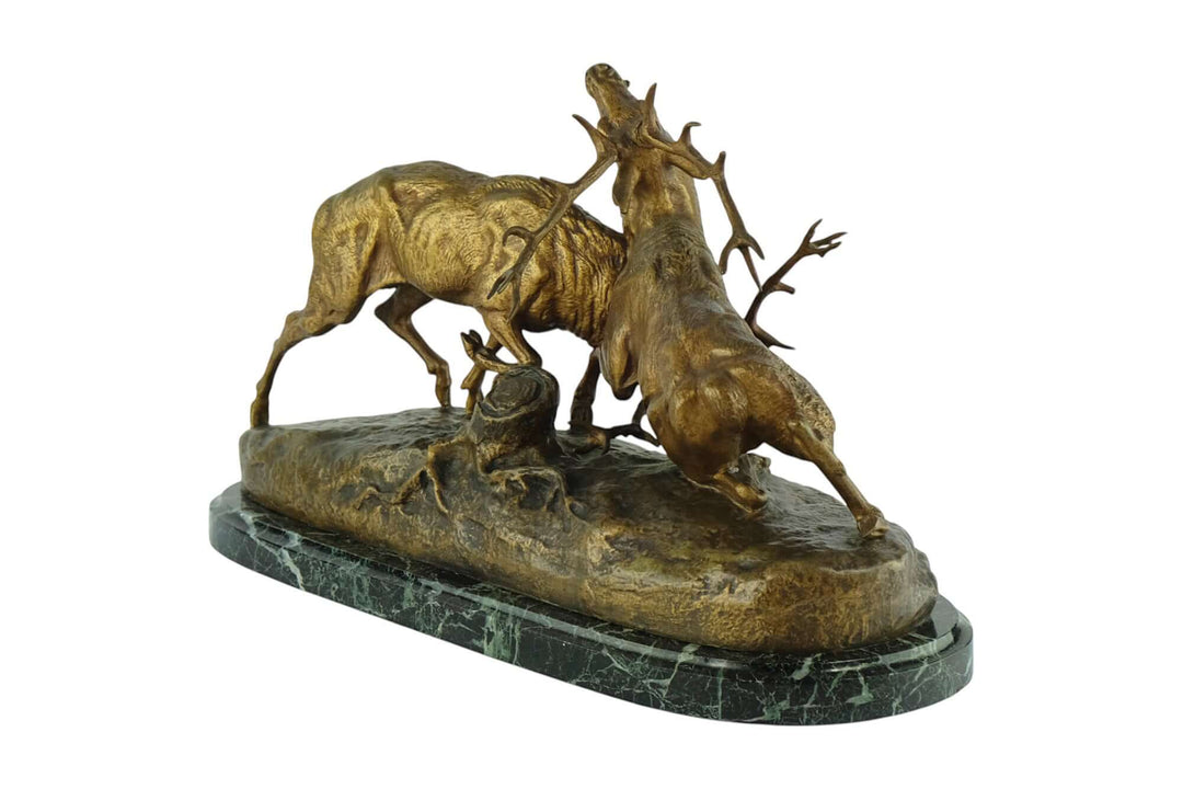 Antique bronze sculpture of two fighting stags by Charles Masson, 19th century, detailed, dramatic display of strength.