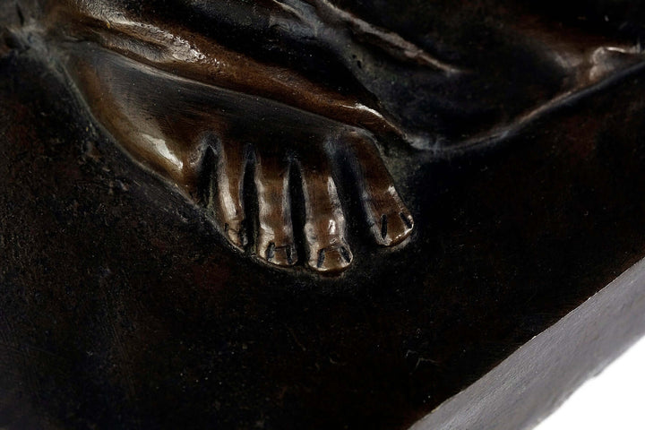 Close-up view of the detailed foot on an antique bronze sculpture of Venus by Milo.