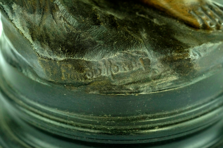 Close-up of signature on bronze patina spelter sculpture by Francois Moreau, antique girl with broken jug.