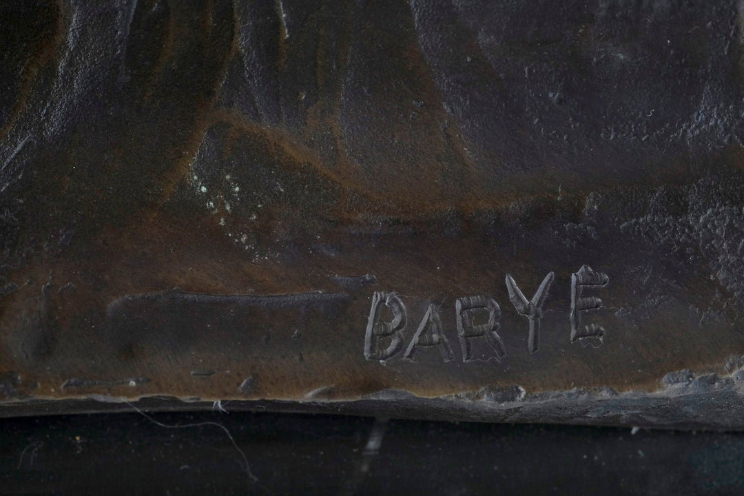 Close-up of the signature on a bronze sculpture by Antoine-Louis Barye, showcasing the artist's craftsmanship.