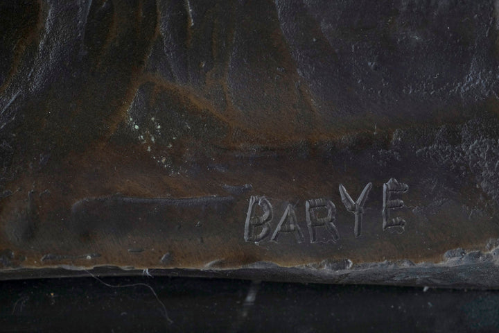 Close-up of the signature on a bronze sculpture by Antoine-Louis Barye, showcasing the artist's craftsmanship.