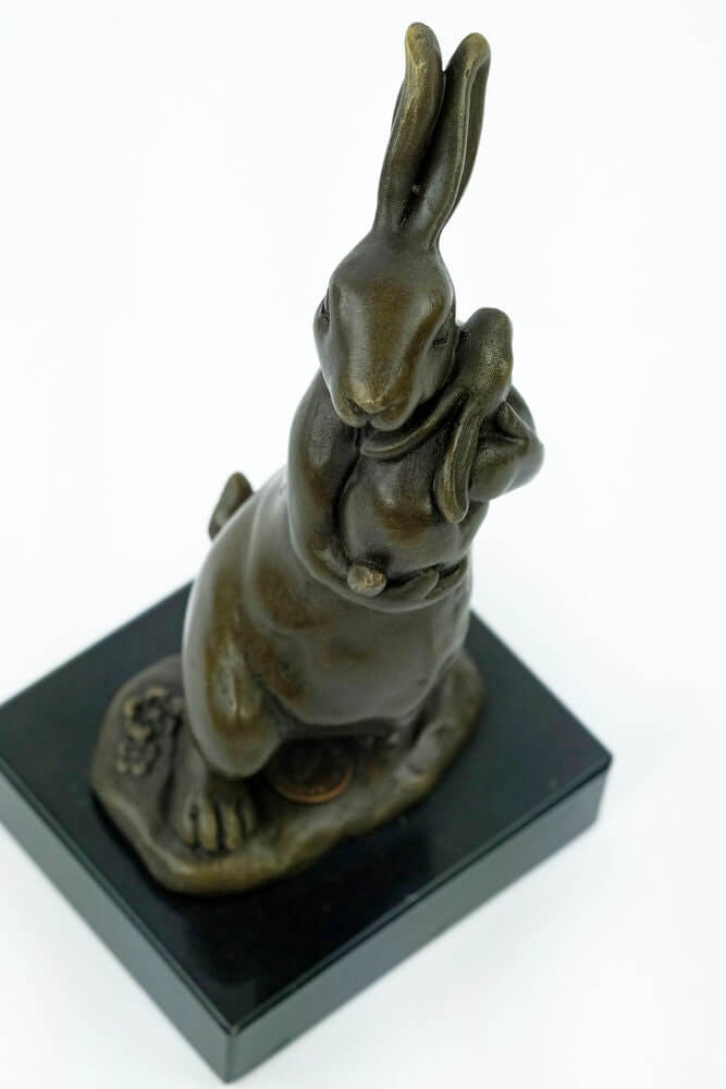 Bronze bunny statue holding a young, elegant art piece on a marble base, perfect for bunny lovers.