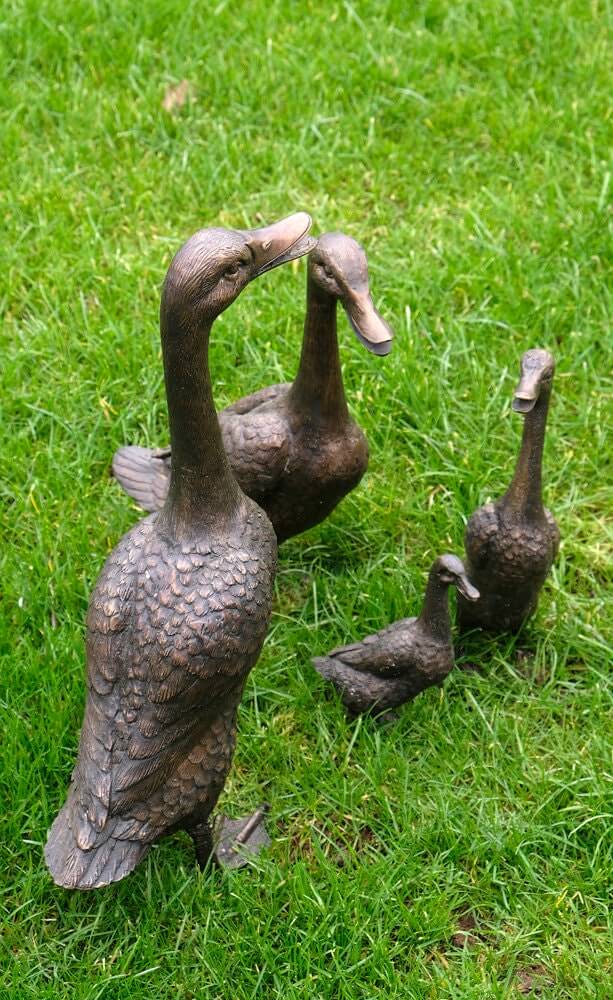 Set of 4 bronze duck family sculptures displayed on green grass, great for indoor or outdoor decoration.