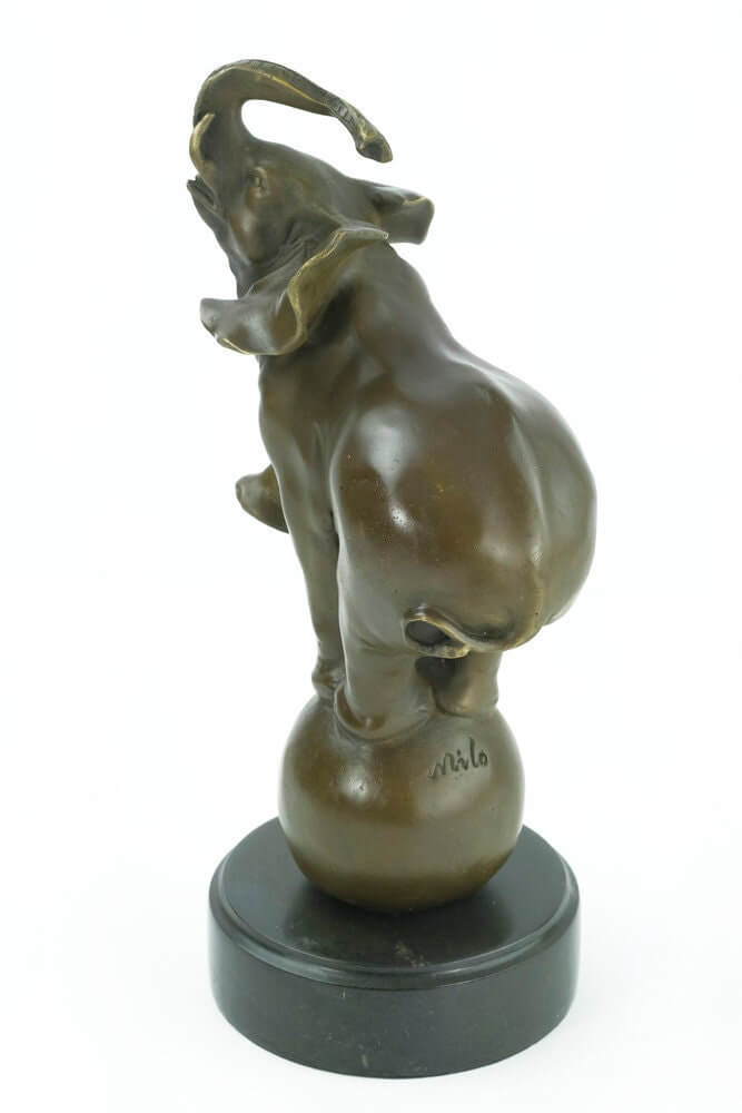 Bronze sculpture of elephant balancing on a ball, signed 'Milo', warm brown patina, mounted on marble base.