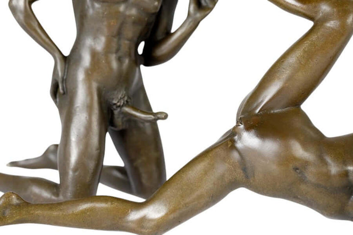 Bronze sculpture of a male and female couple in an intimate pose, showcasing detailed craftsmanship and dynamic positioning.