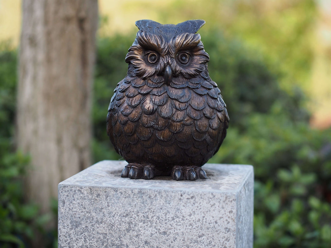 Charming bronze sculpture of a Eurasian eagle owl with detailed feathers, expressive eyes, and distinctive ear tufts.