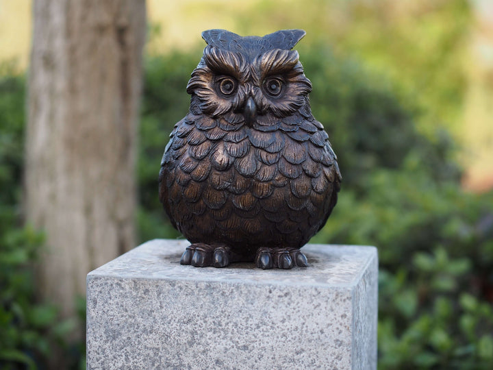 Charming bronze sculpture of a Eurasian eagle owl with detailed feathers, expressive eyes, and distinctive ear tufts.