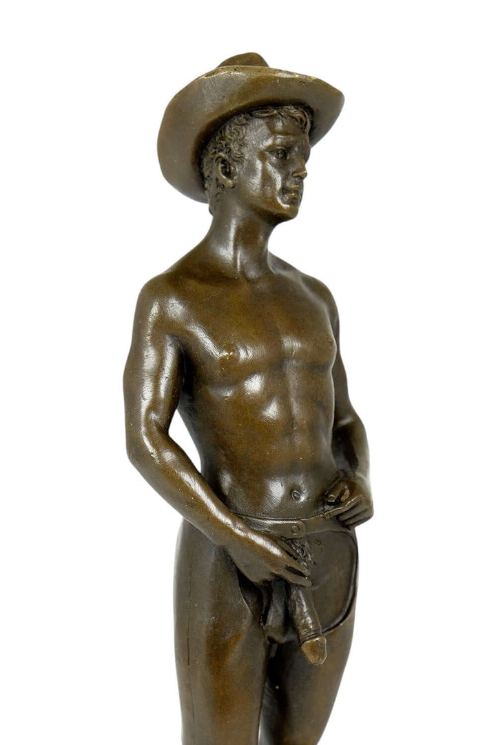 Bronze sculpture of a gay cowboy in a confident pose, showcasing erotic male art with fine details.