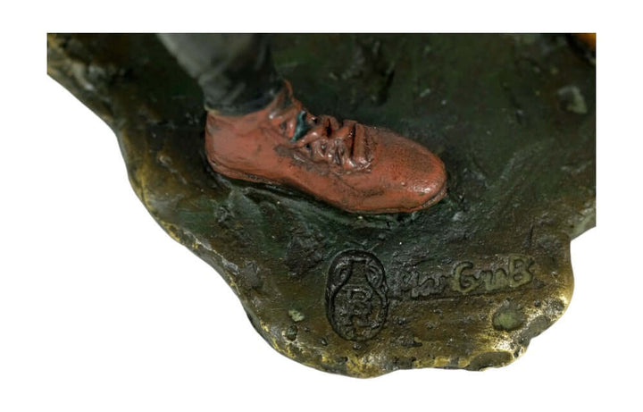 Close-up of the bronze golfer sculpture's shoe and signature, showcasing the vintage Viennese style craftsmanship.