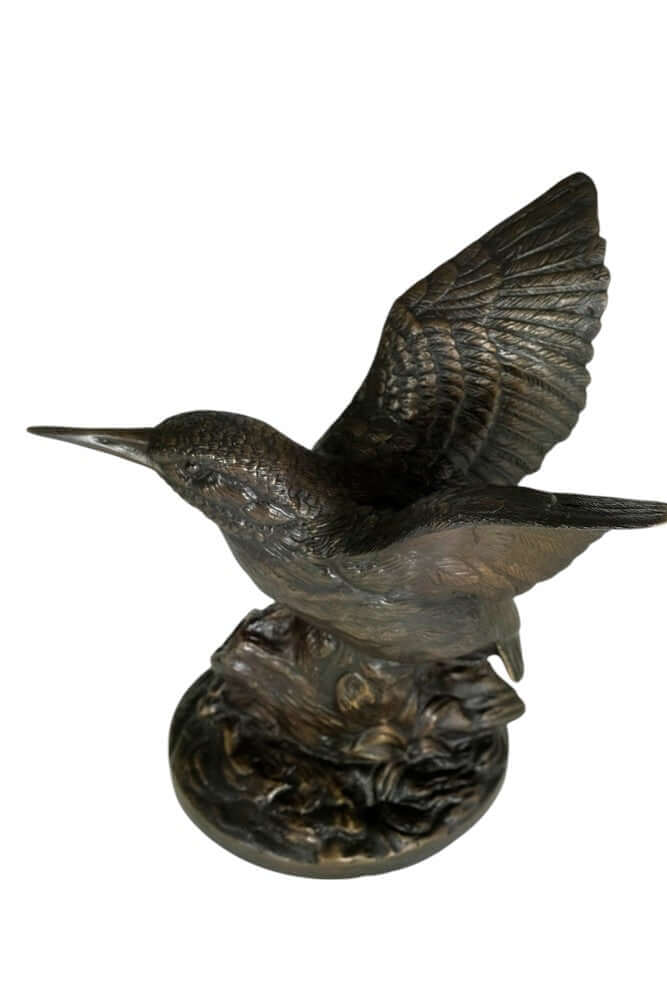 Bronze sculpture of a kingfisher with wings spread, perched on a detailed tree trunk. Decorative art piece.