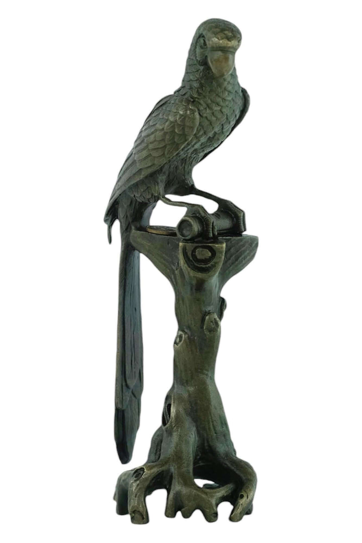 Bronze macaw sculpture on tree trunk with detailed feather design, signed by artist Nick, 18 cm tall.