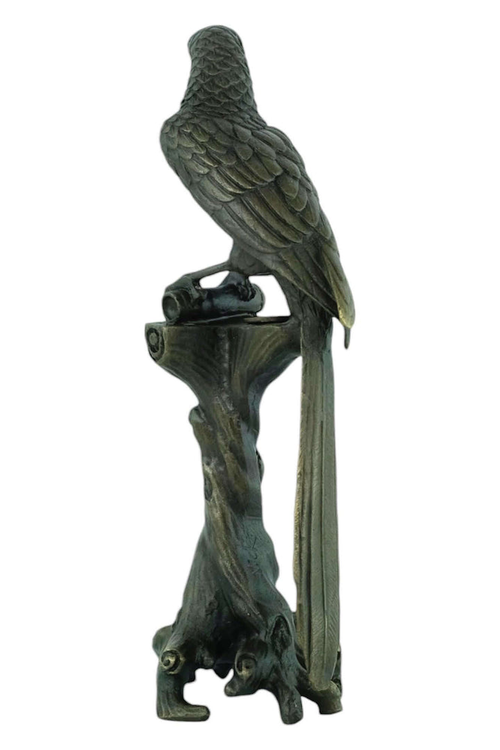 Bronze sculpture of a macaw on a detailed tree trunk, warm patina, 18 cm tall, signed by artist Nick.
