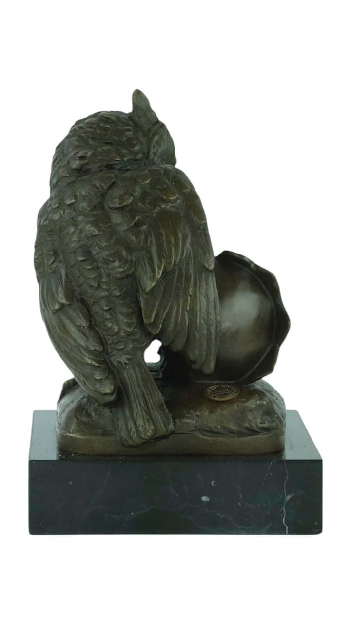 Bronze sculpture of an owl beside a crowned skull, signed J.B. Clesinger, mounted on marble, 17x13 cm.