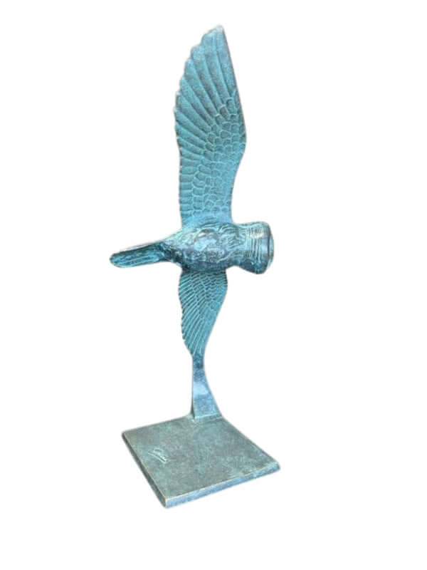 Elegant bronze owl sculpture in mid-flight with outstretched wings, perfect for outdoor display in garden settings.