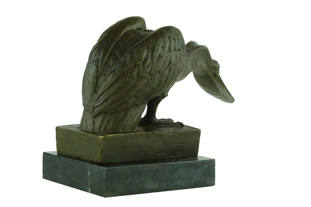 Bronze pelican sculpture seeking fish on marble base, detailed craftsmanship, signed by Milo, 24x40 cm.