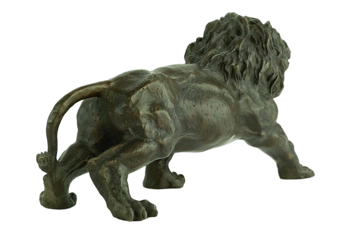 Bronze sculpture of a walking roaring lion by C. Valton, showcasing realistic details and powerful stance.
