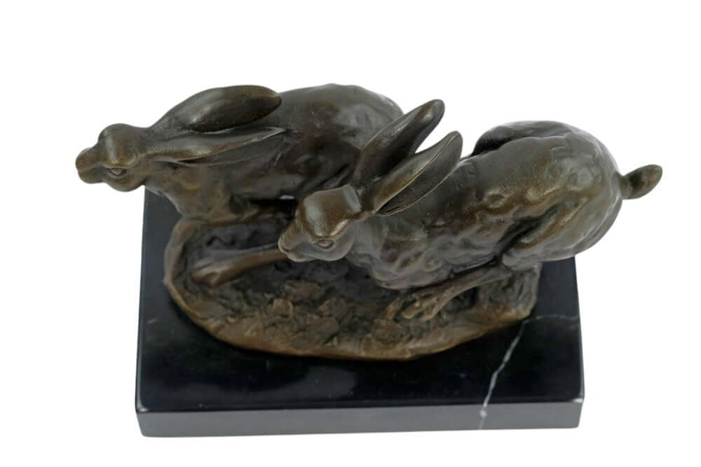 Stunning bronze sculpture of two running hares on a marble base, capturing dynamic action and intricate details.
