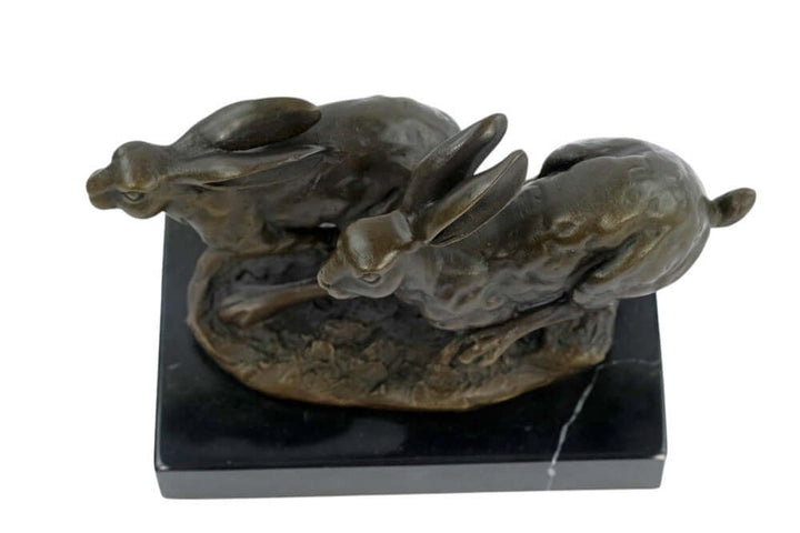 Stunning bronze sculpture of two running hares on a marble base, capturing dynamic action and intricate details.