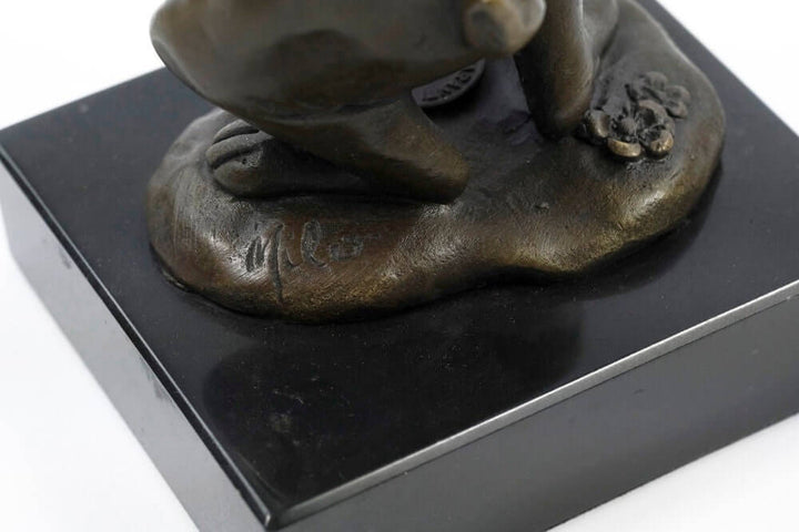 Close-up of signed Milo bronze bunny statue on a black marble base, showcasing fine animal art details.