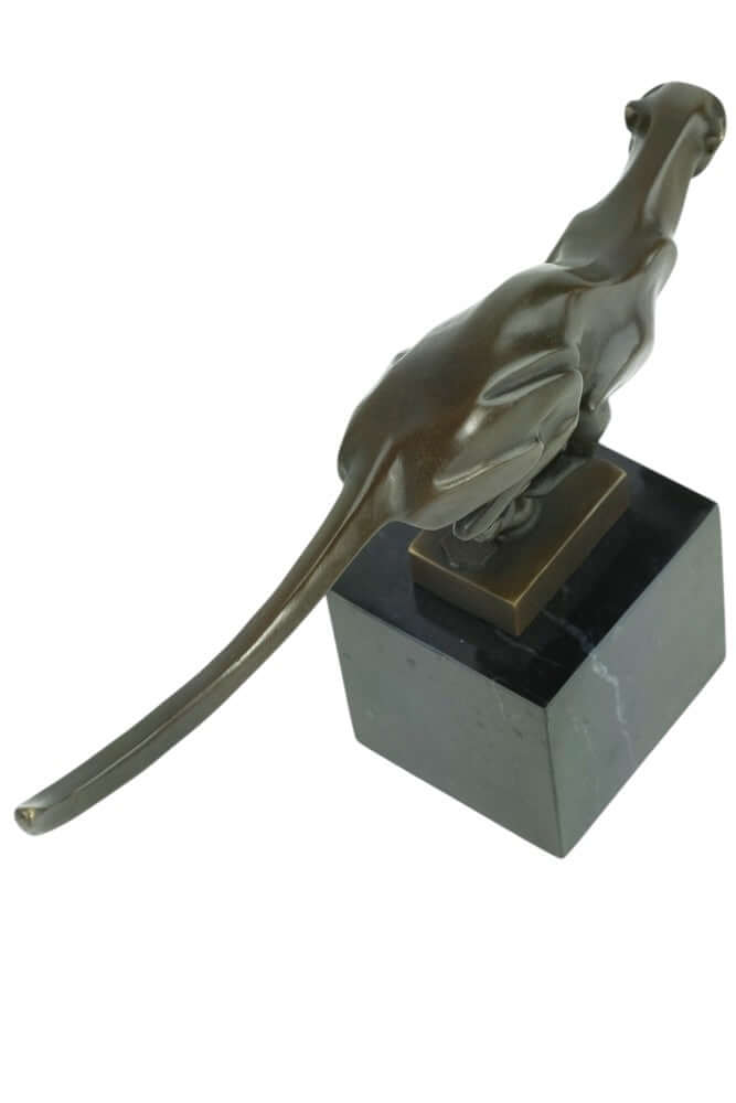 Bronze sculpture of a cheetah running, mounted on a marble base, showcasing sleek design and fine craftsmanship.