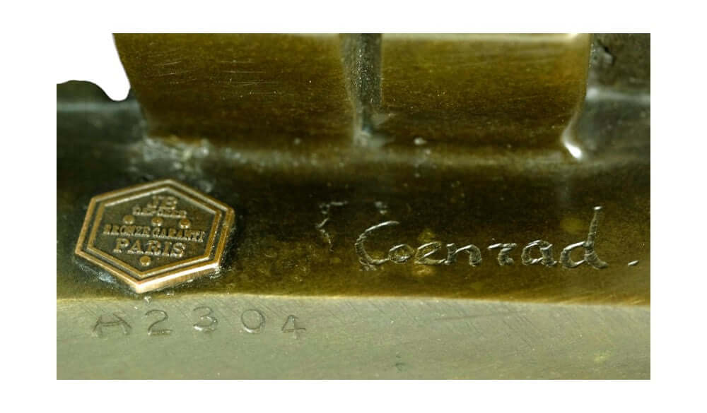 Signature and maker's mark of F. Conrad on the bronze sculpture base, showcasing craftsmanship and authenticity.