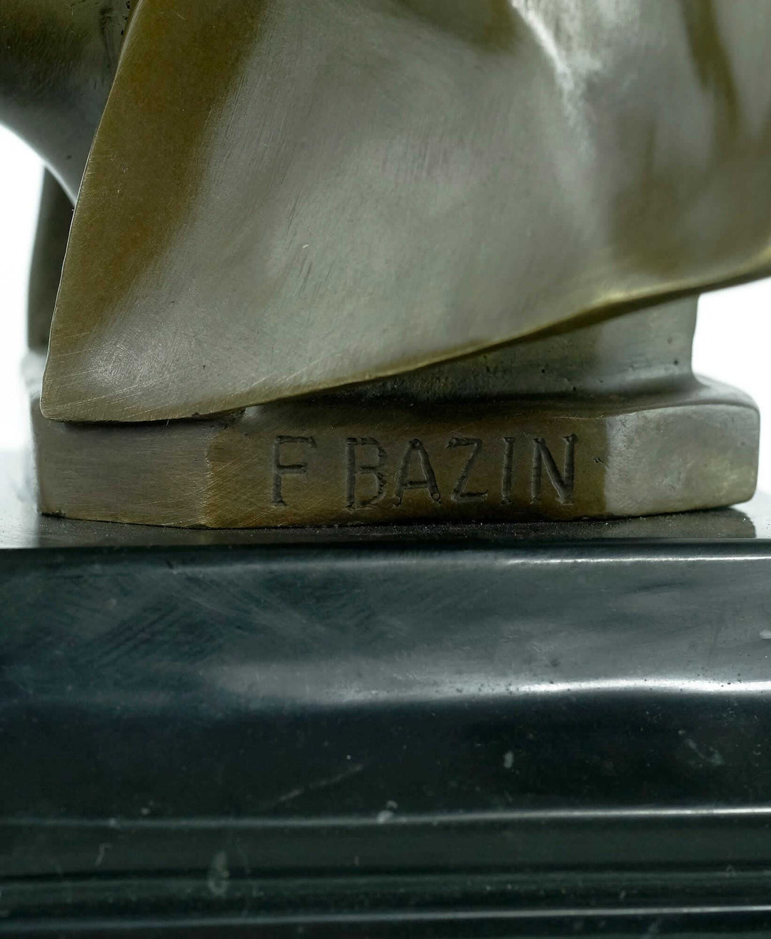 Signature F Bazin on a bronze sculpture of an elephant head, Art Deco style, mounted on a marble base.