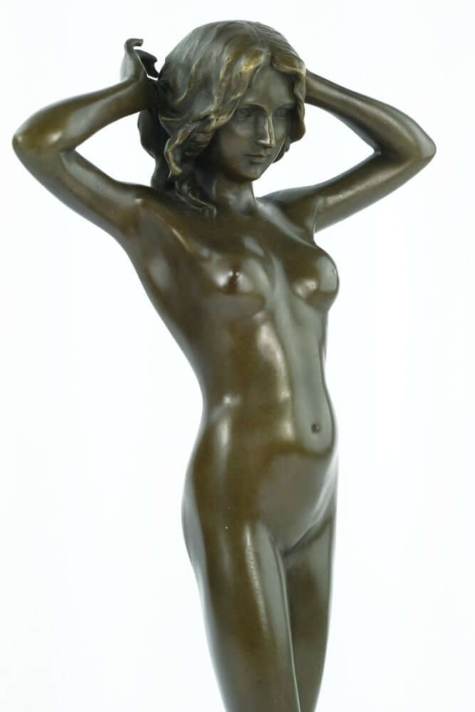 Bronze sculpture of a nude female playing with her hair, showcasing beauty and grace, mounted on a marble base.