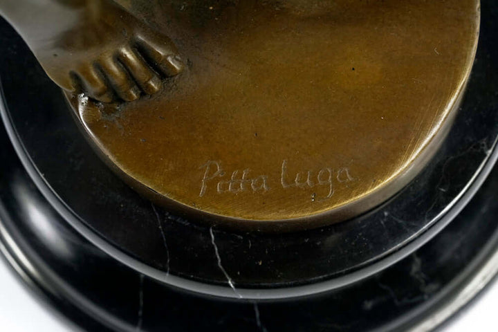 Close-up of the signature "Pittaluga" on a bronze sculpture's base, highlighting craftsmanship and artistry.