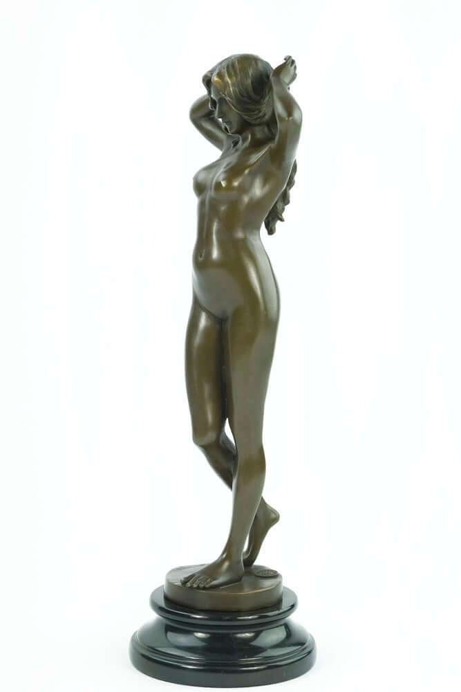 Bronze sculpture of a female nude playing with her hair, mounted on a round marble base. Height: 38 cm.