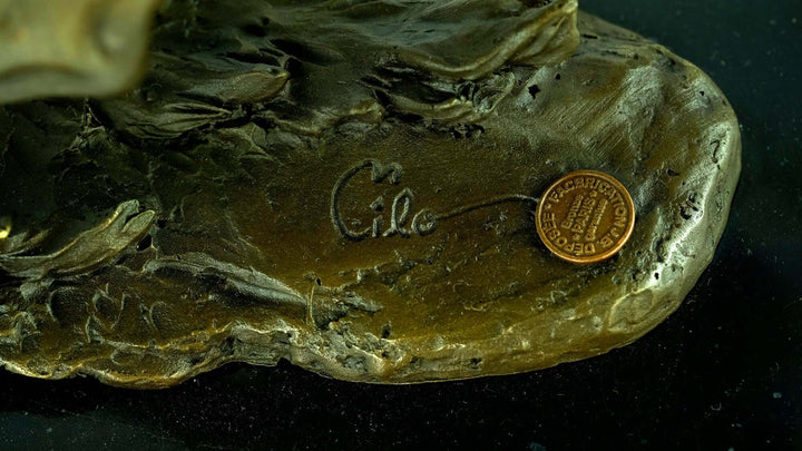 Signature 'Milo' and foundry stamp on the base of a detailed bronze sculpture of a galloping horse.