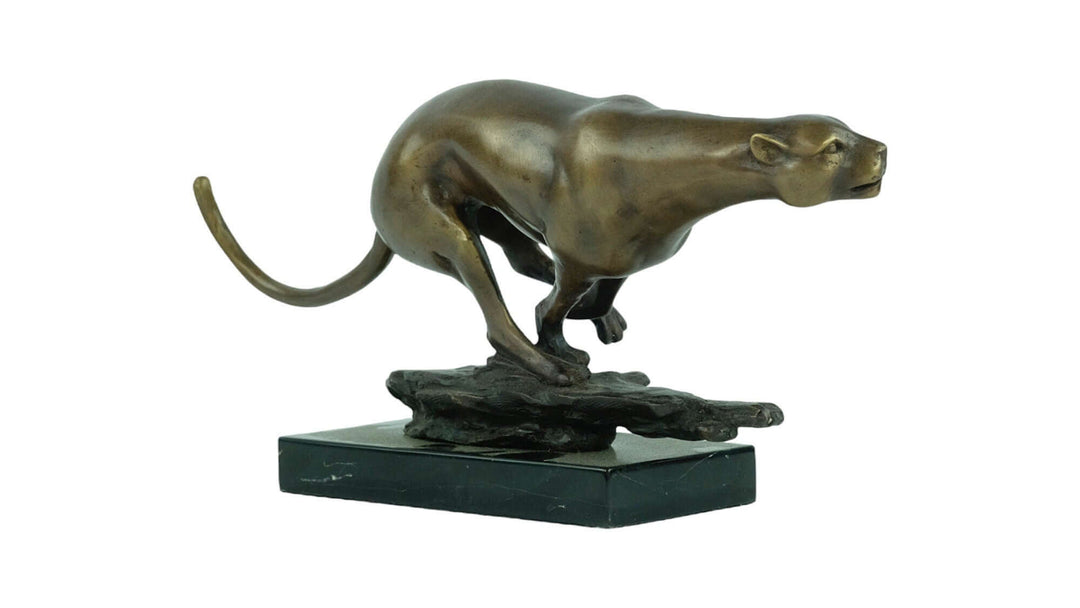 Bronze sculpture of a jaguar running at full speed on marble base, showcasing detailed animal artistry and design.