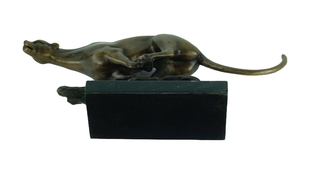 Bronze sculpture of a jaguar running at full speed, mounted on a sleek marble base, showcasing fine craftsmanship.