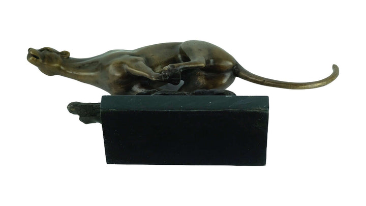 Bronze sculpture of a jaguar running at full speed, mounted on a sleek marble base, showcasing fine craftsmanship.