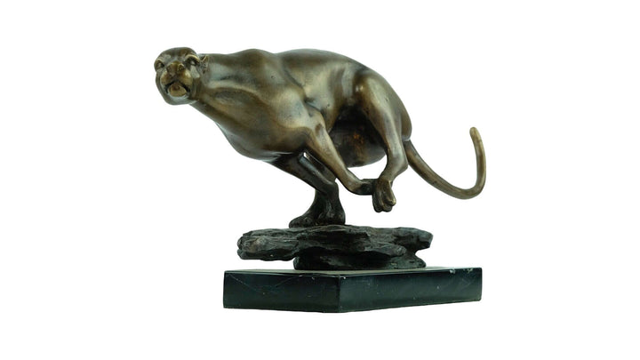 Bronze sculpture of a jaguar in motion, showcasing true-to-nature design and powerful appearance on a marble base.