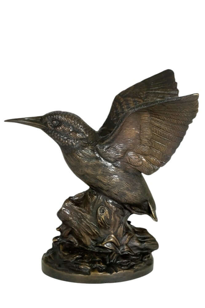 Detailed bronze sculpture of a king fisher perched on a tree trunk, wings spread, warm patina finish.