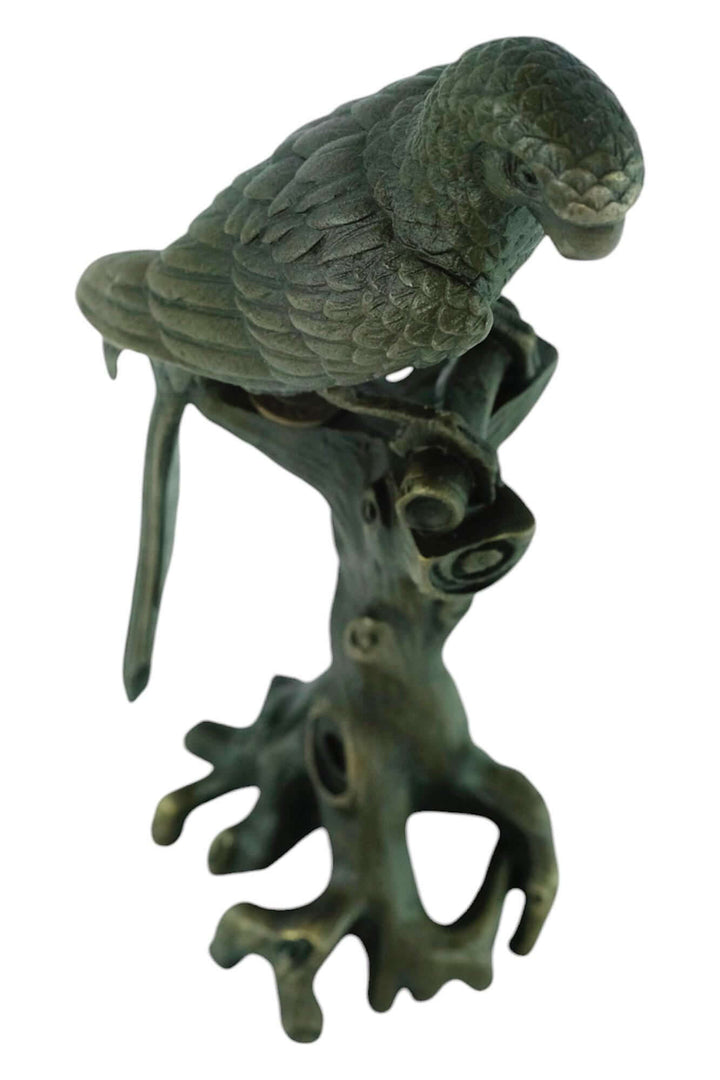 Bronze macaw sculpture sitting on tree trunk with detailed design, warm patina, height 18 cm, signed by artist Nick.