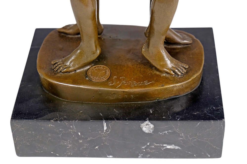 Close-up of bronze sculpture base showing feet and signature, symbolizing love and connection between male lovers.