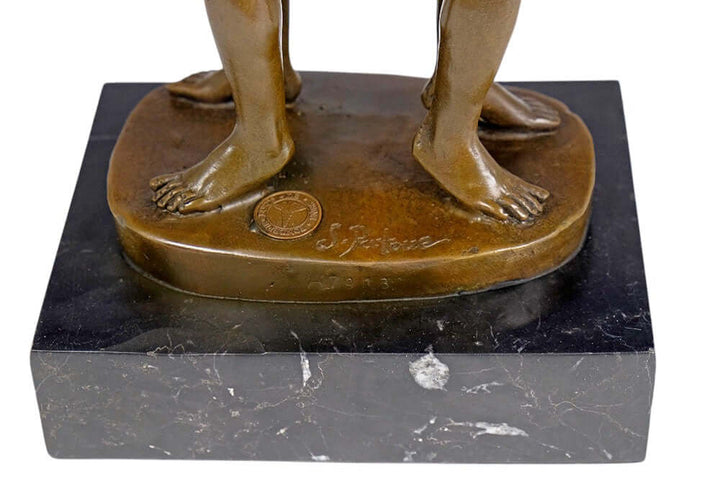 Close-up of bronze sculpture base showing feet and signature, symbolizing love and connection between male lovers.