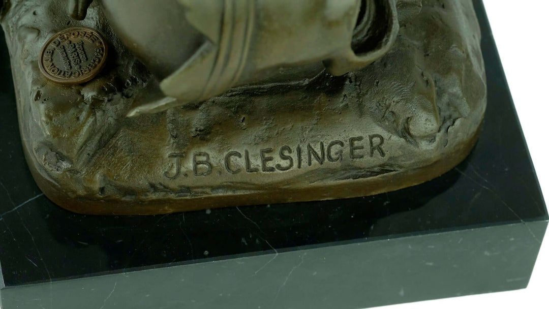 Close-up of the signature 'J.B. Clesinger' on a detailed bronze owl and skull sculpture base.