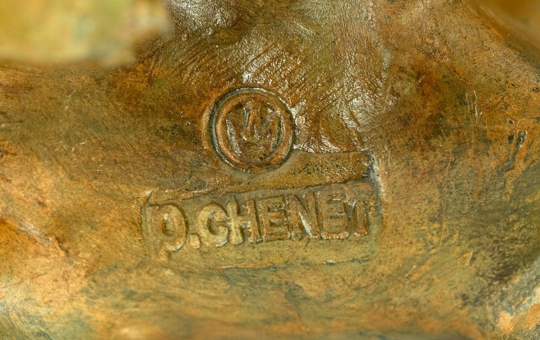 Signature and foundry stamp of Pierre Chenet on bronze polar bear sculpture, showcasing craftsmanship.