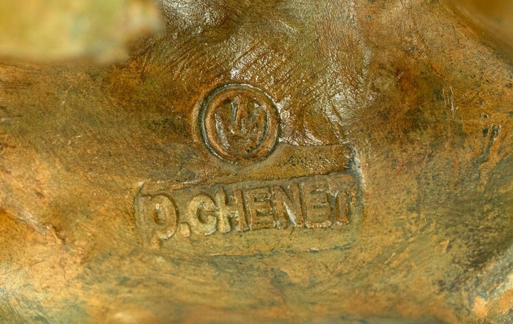 Signature and foundry stamp of Pierre Chenet on bronze polar bear sculpture, showcasing craftsmanship.
