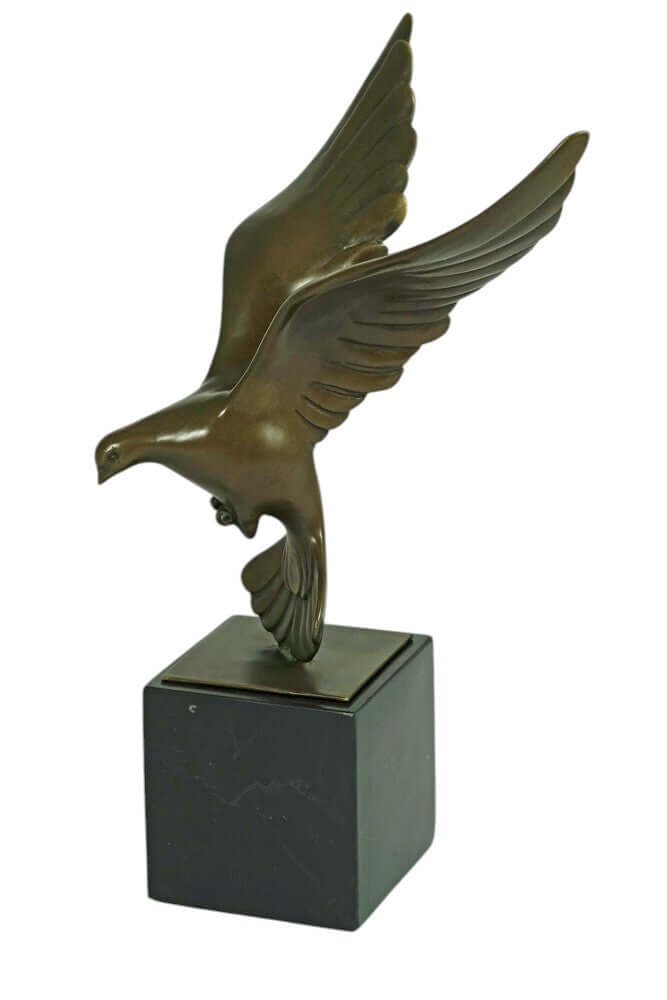 Bronze sculpture of a descending pigeon with wings spread, mounted on a black marble base. Height: 30 cm.