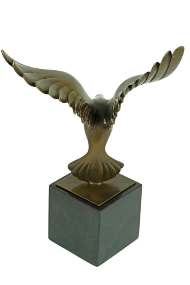 Bronze sculpture of a pigeon descending with wings spread, mounted on a square marble base, Art Deco style.